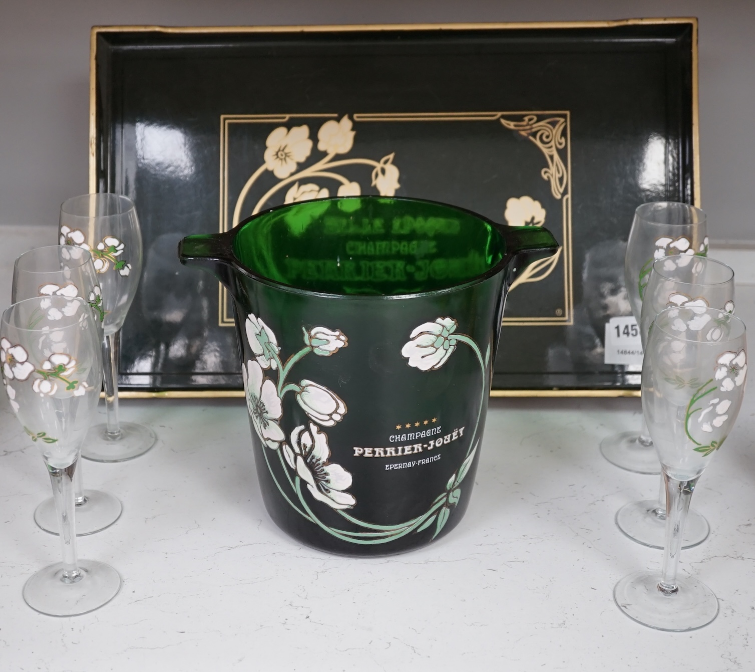 After an Emile Galle design, a Perrier Jouet ‘Belle Epoque’ champagne bucket, seven glass champagne flutes and a tray, largest 48cm wide. Condition - fair.